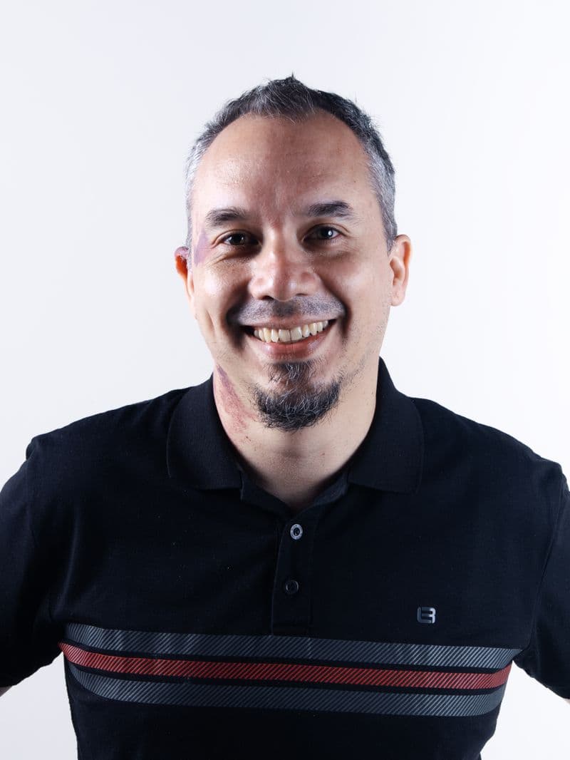 Portrait of Dr. Marcus Reed, DC, smiling in a dark polo shirt
