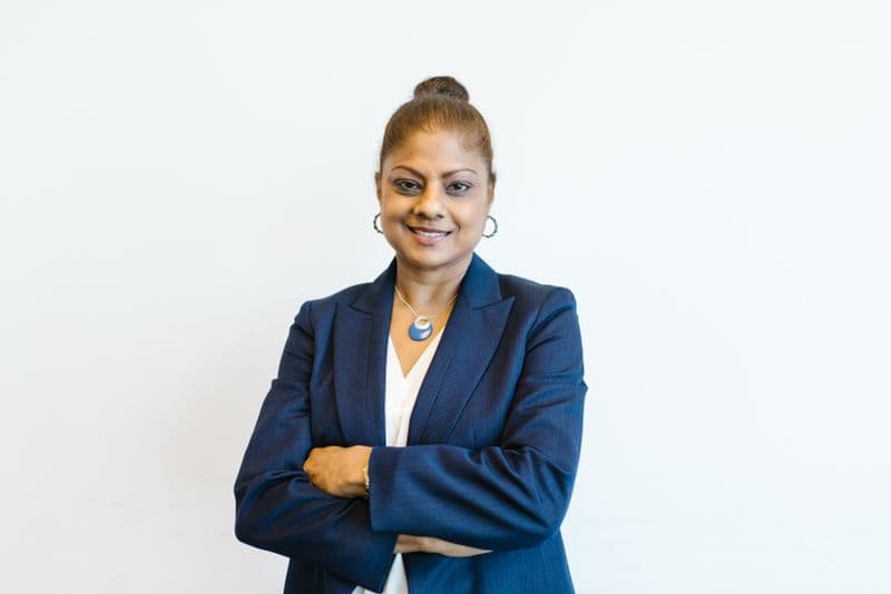 Portrait of Dr. Simone Carter, DC, smiling in a navy blazer